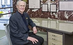 "Peter Salk at his father's desk during ribbon cutting"